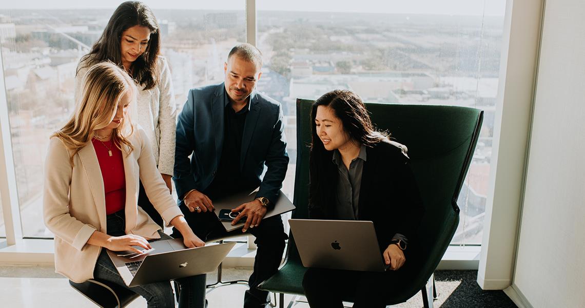 Group of Team Members Reviewing a Presentation Together